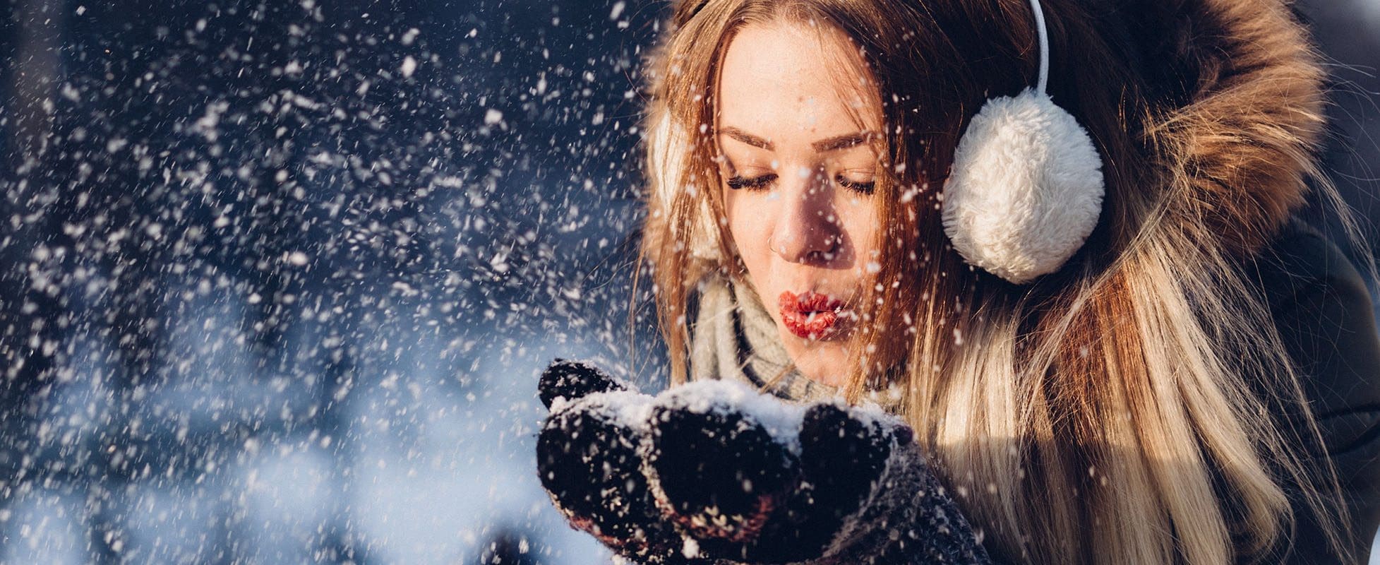 woman blowing snow in the air